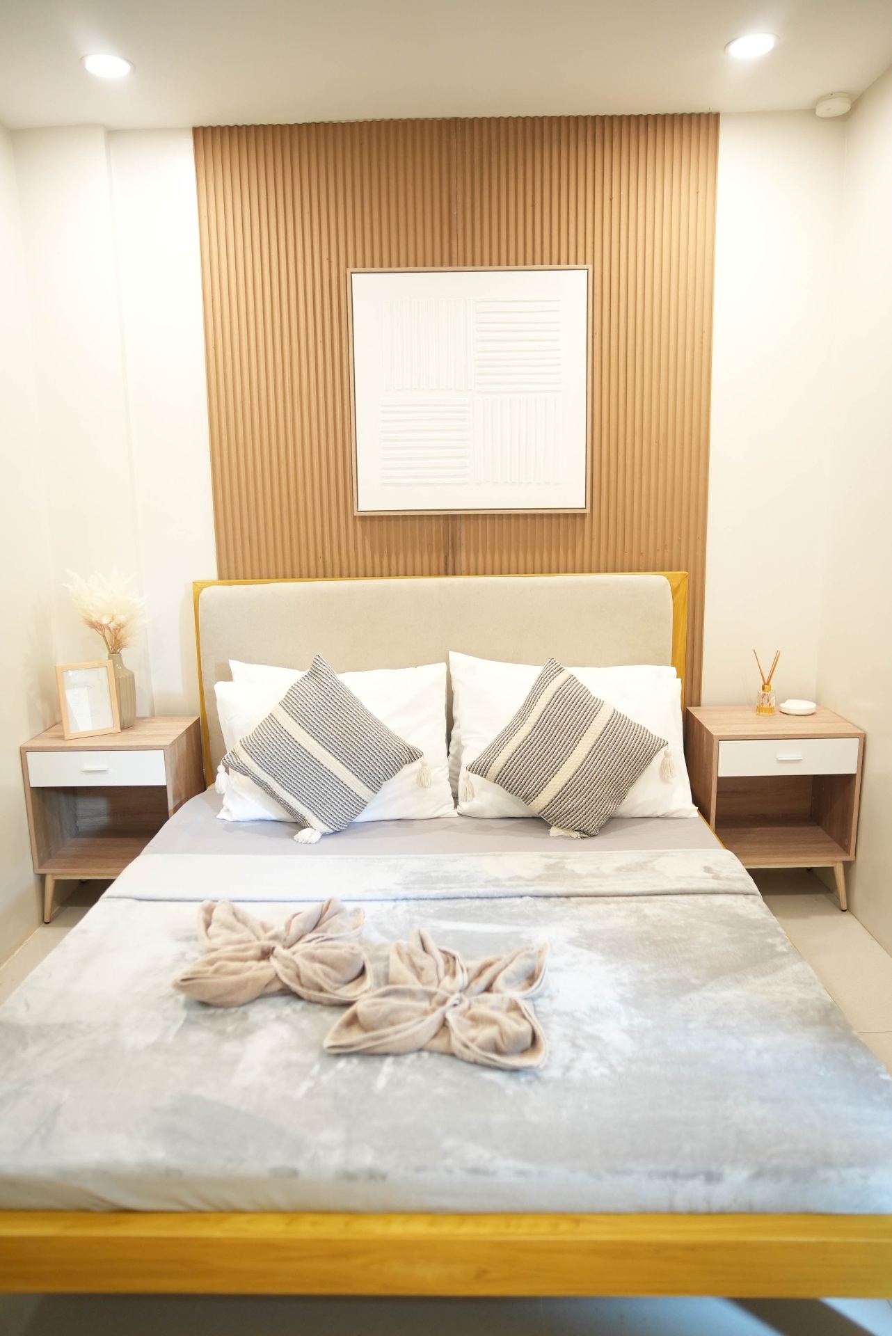 Queen bedroom with fluted wood accent wall